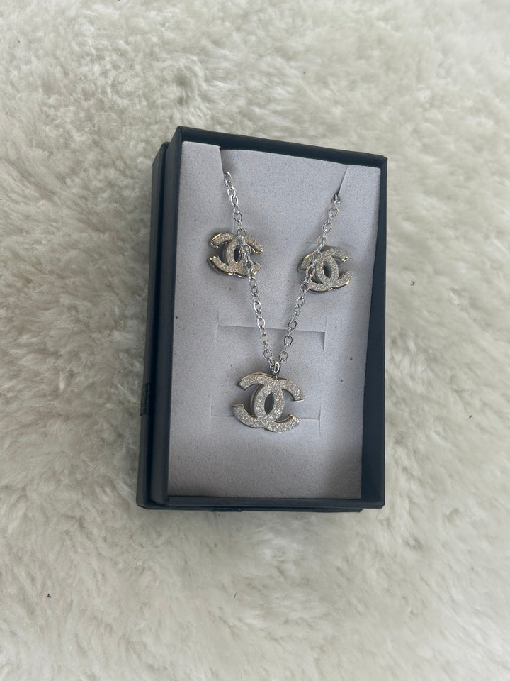 Silver matching necklace and earrings with sparkling crystal detailing