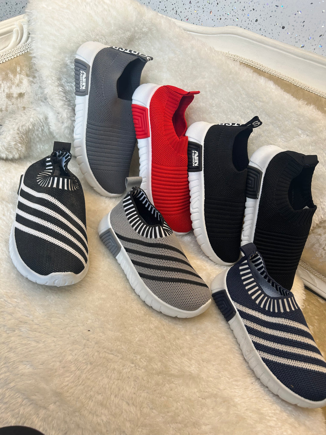 Children’s slip on trainers with white soles 