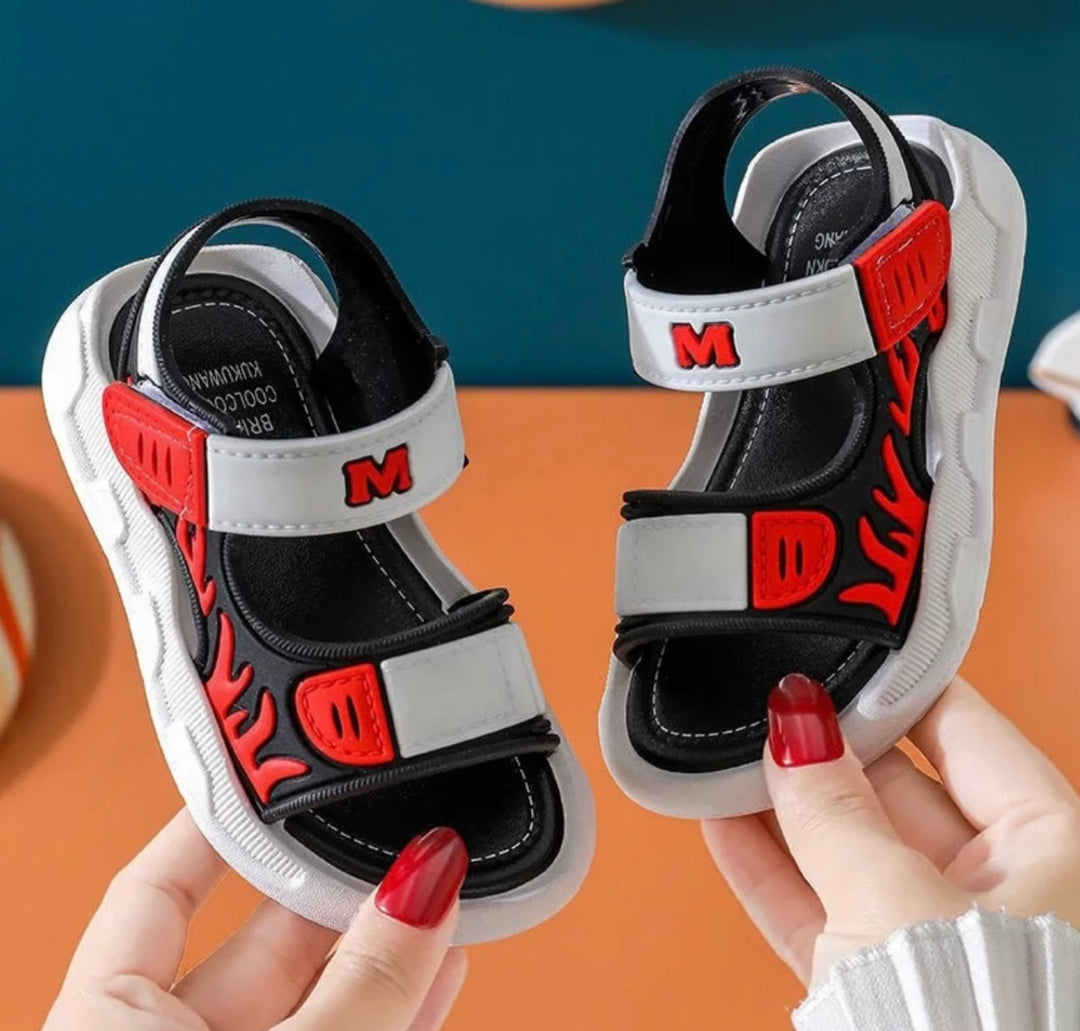 red sandals for boys with flame detail up the sides of the sandal 