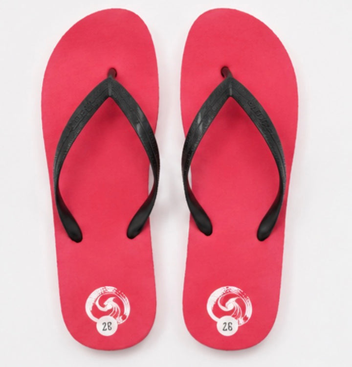 Red flip flops with black straps and lightweight foam sole