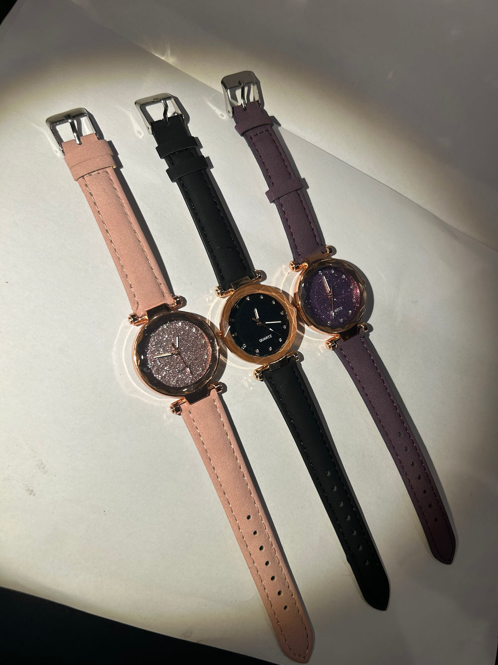 Glitter-faced watches with rose gold hardware and adjustable straps 