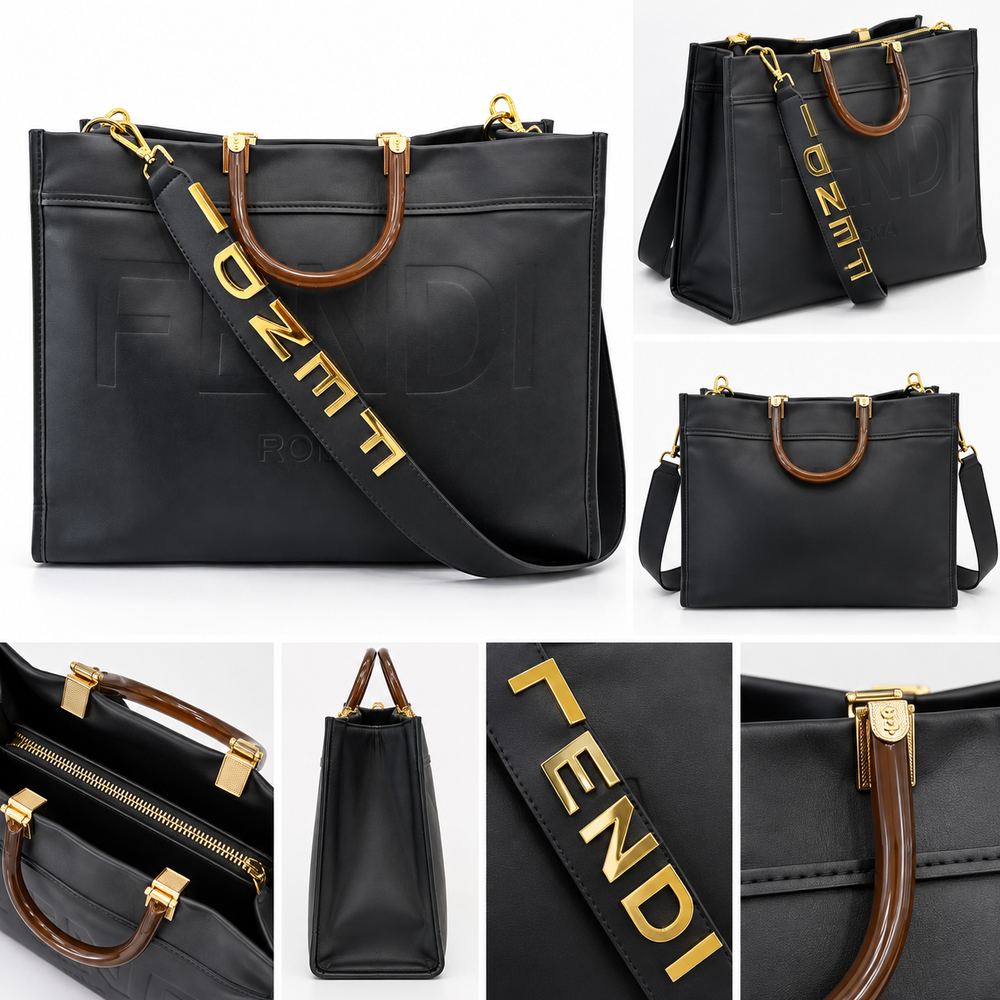 Large black embossed tote bag with brown handles, gold hardware and wide statement shoulder strap
