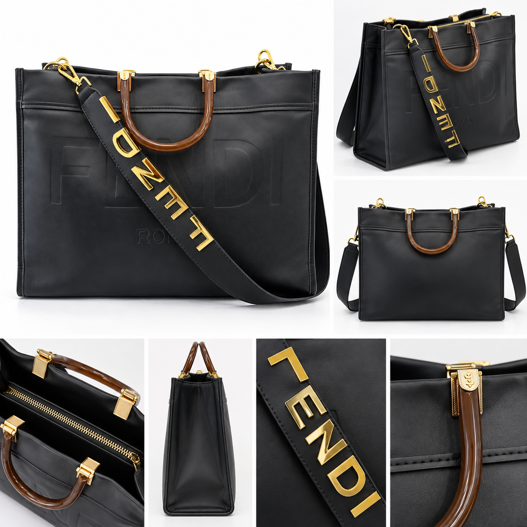 Large black embossed tote bag with brown handles, gold hardware and wide statement shoulder strap