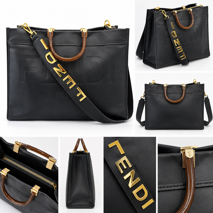 Large black embossed tote bag with brown handles, gold hardware and wide statement shoulder strap