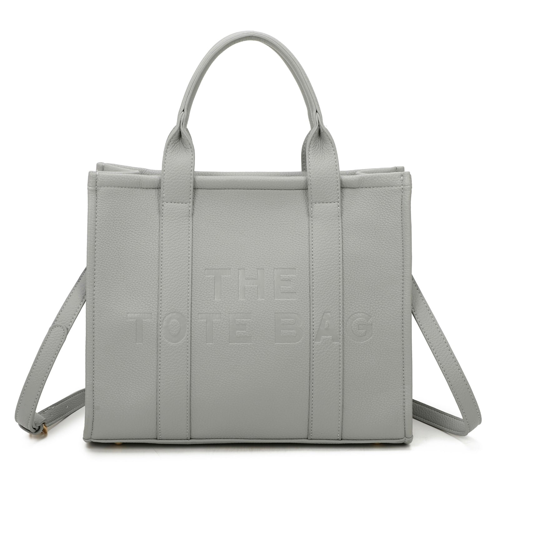 A grey tote bag with embossed ‘The Tote Bag’ text, structured design with top handles and detachable shoulder strap