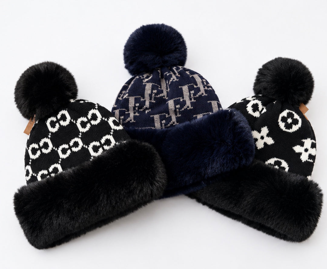 Luxury faux fur pom pom knitted winter hats in black and navy with soft faux fur trim and warm fleece lining.