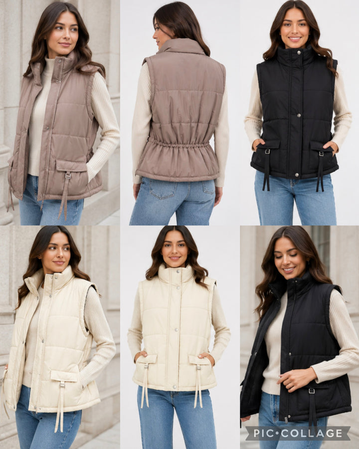 Women’s sleeveless padded gilet available in black, cream and taupe featuring a quilted puffer design, high neck, front popper fastening, buckle pocket details and cinched waist