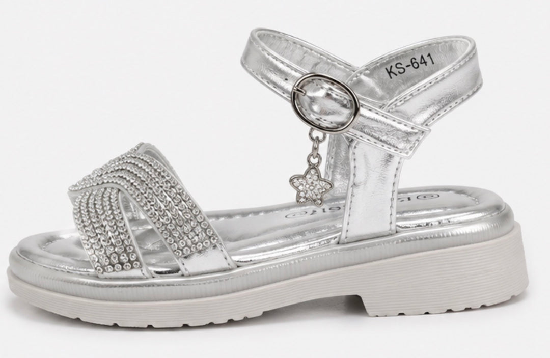 Girls silver diamante sandals with sparkling crossover straps, metallic silver finish and a dangling crystal clover charm
