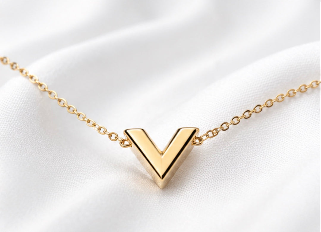 Gold V pendant necklace, featuring a minimalist stainless steel design on a delicate gold chain