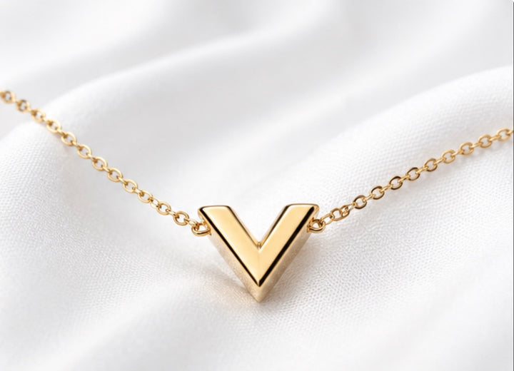 Gold V pendant necklace, featuring a minimalist stainless steel design on a delicate gold chain