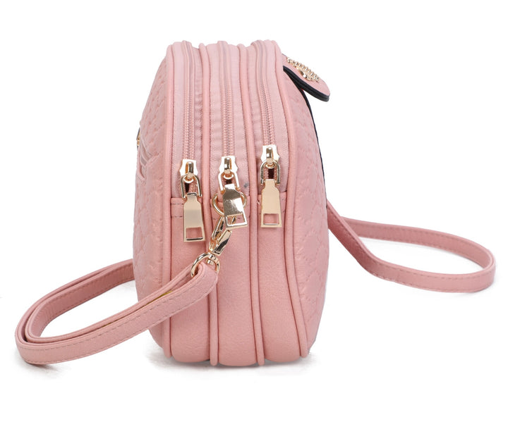 A pink quilted bee design cross body bag side view with a detachable and adjustable strap, featuring golden tone metal hardware.