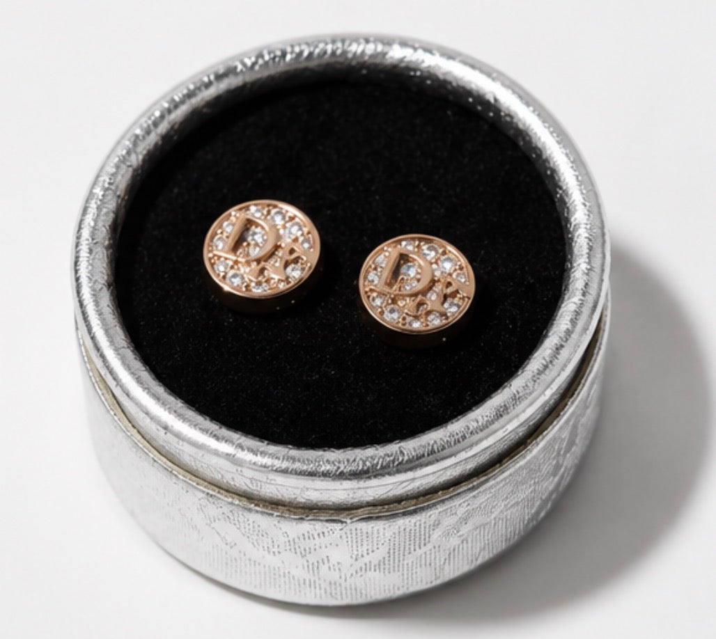 Rose gold crystal letter stud earrings displayed in a silver jewellery box