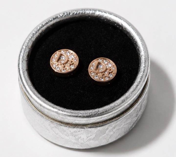 Rose gold crystal letter stud earrings displayed in a silver jewellery box