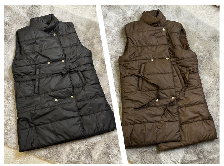 Two mid-length gillets, one in black and one in brown, laid out flat with ribbon belt