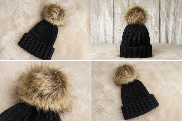 Children’s black ribbed knit bobble hat with a large beige faux fur pom pom