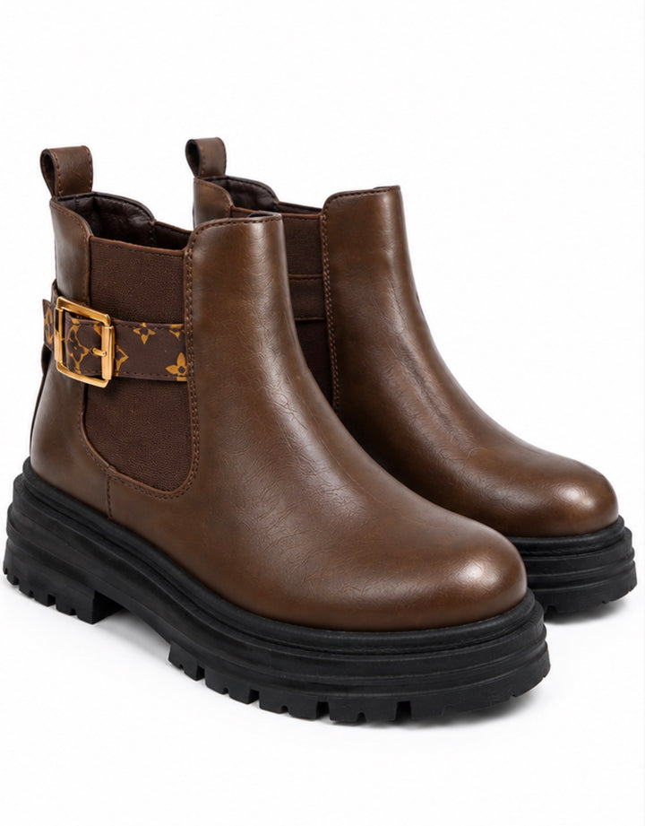 Chocolate brown chunky Chelsea ankle boots with patterned buckle strap and black cleated sole