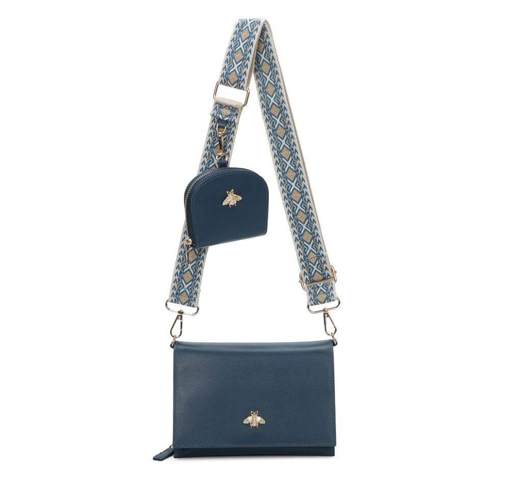 Navy blue handbag with a patterned strap on a white background