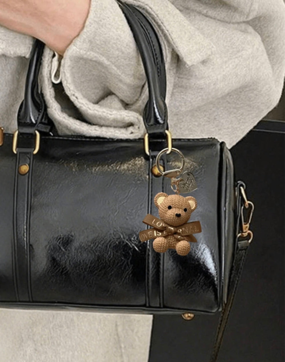    Beige teddy bear keyring charm with ribbon bow and gold heart pendant.