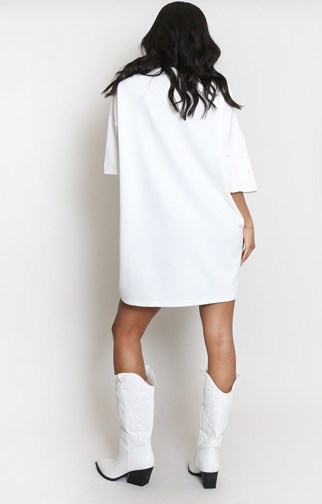 back of Person wearing a white t-shirt dress and white cowboy boots