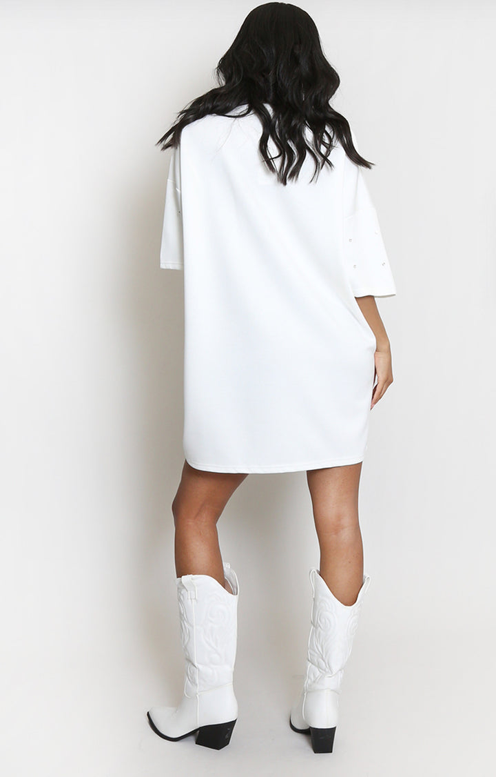 back of Person wearing a white t-shirt dress and white cowboy boots