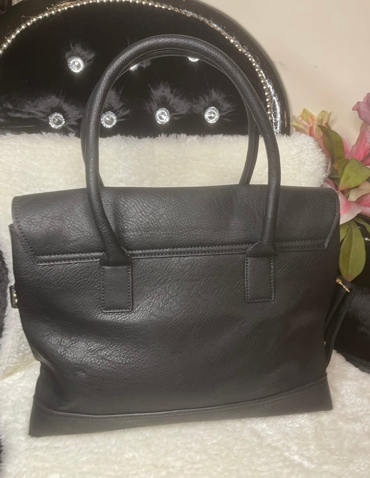A classic black handbag with elegant gold detailing, featuring a flap with twist metal lock closure, twin shoulder straps, and golden tone metal hardware.