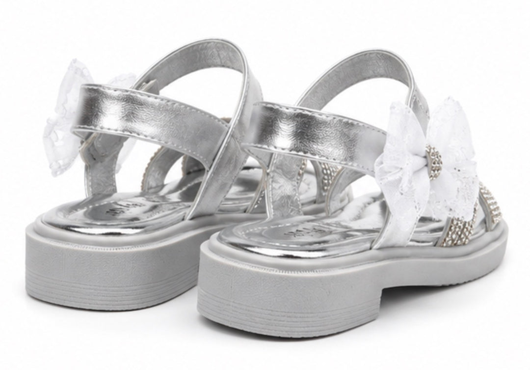Silver girls’ sandals with sparkling diamanté crossover straps, oversized glitter mesh bow detail 