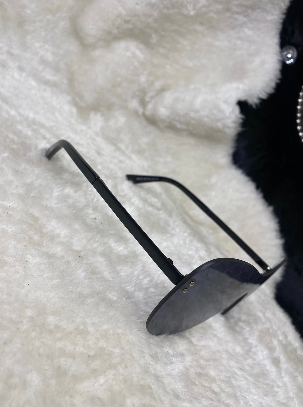 A pair of black cross design sunglasses