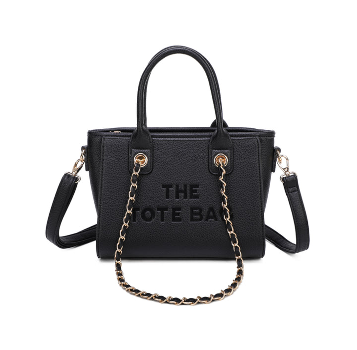 A black tote bag with a chain handle, featuring a front zipper pocket and gold tone metal hardware. The ‘THE TOTE BAG&