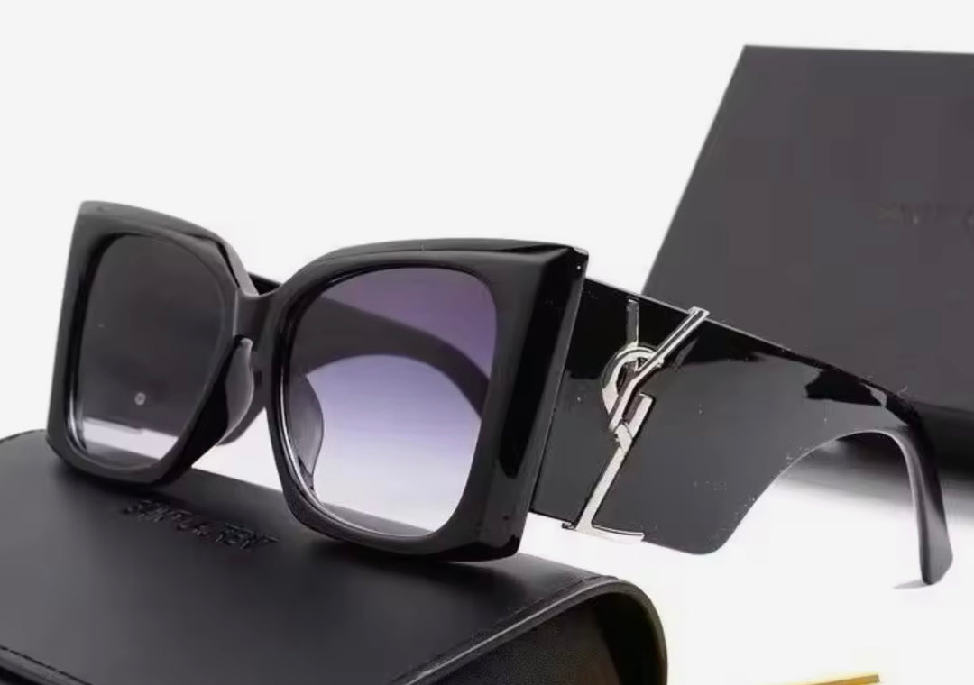 Black chunky sunglasses with a silver logo 
