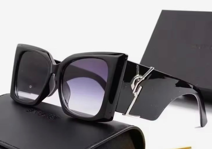 Black chunky sunglasses with a silver logo 