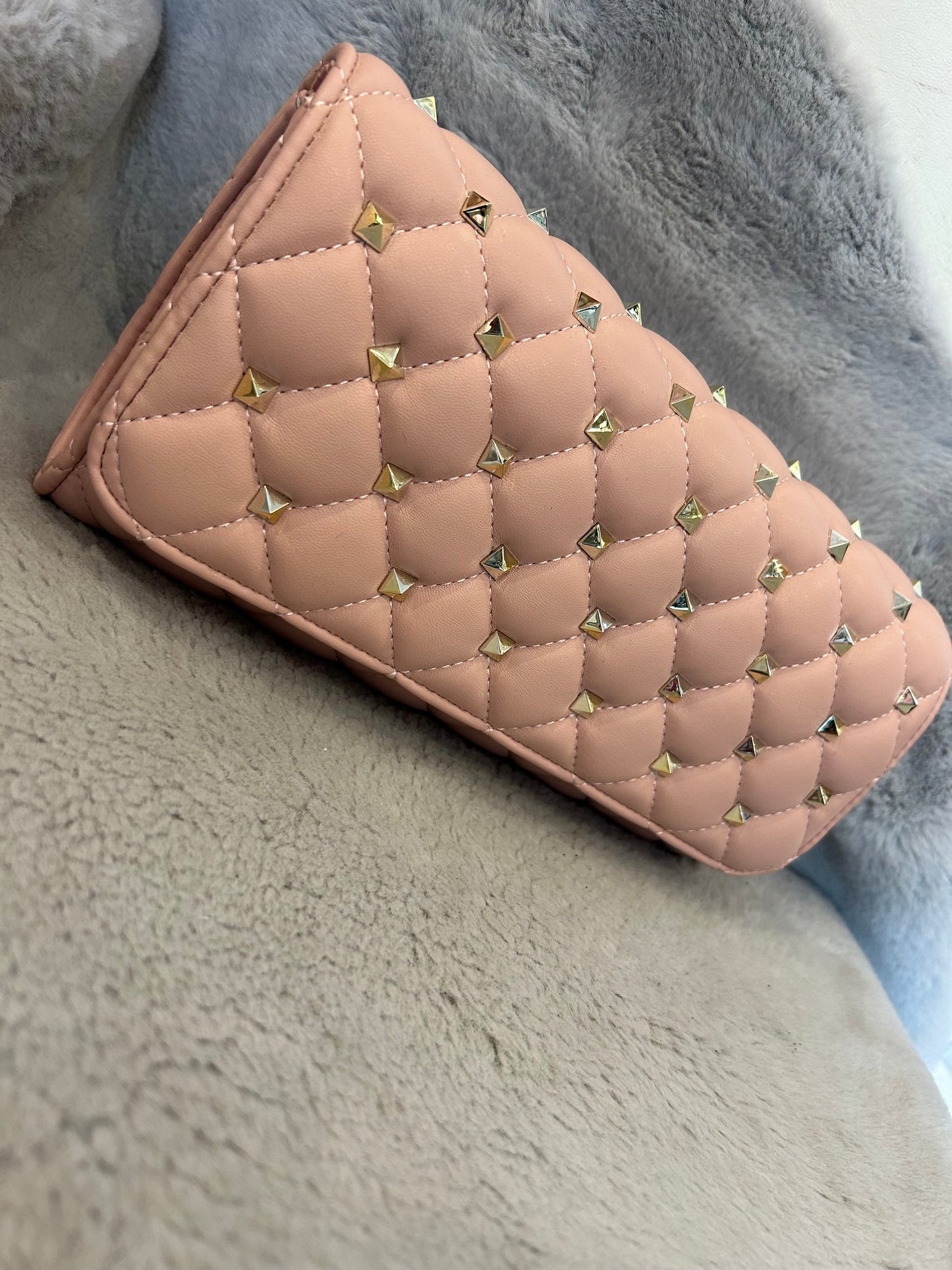 Pink studded clutch bag