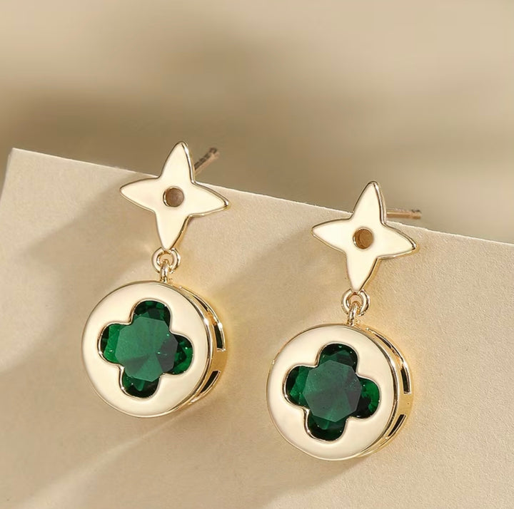     Gold clover drop earrings with green crystal stone detail