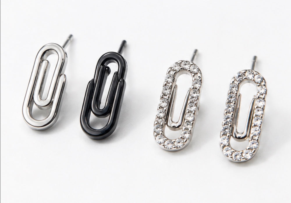 Minimalist silver and crystal paperclip earrings close-up
