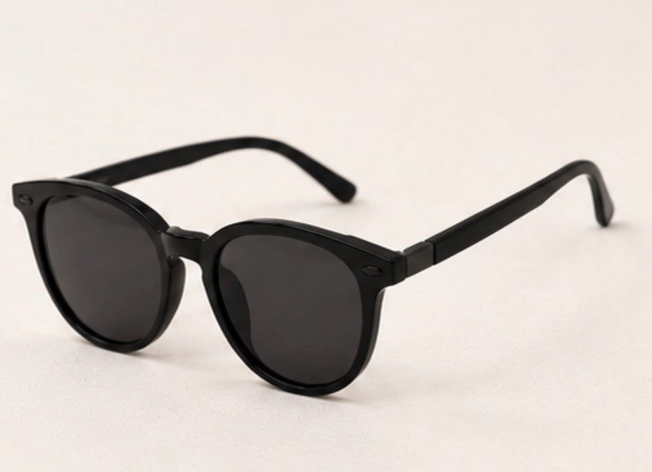 Black round frame sunglasses with dark tinted lenses and black hardware detail