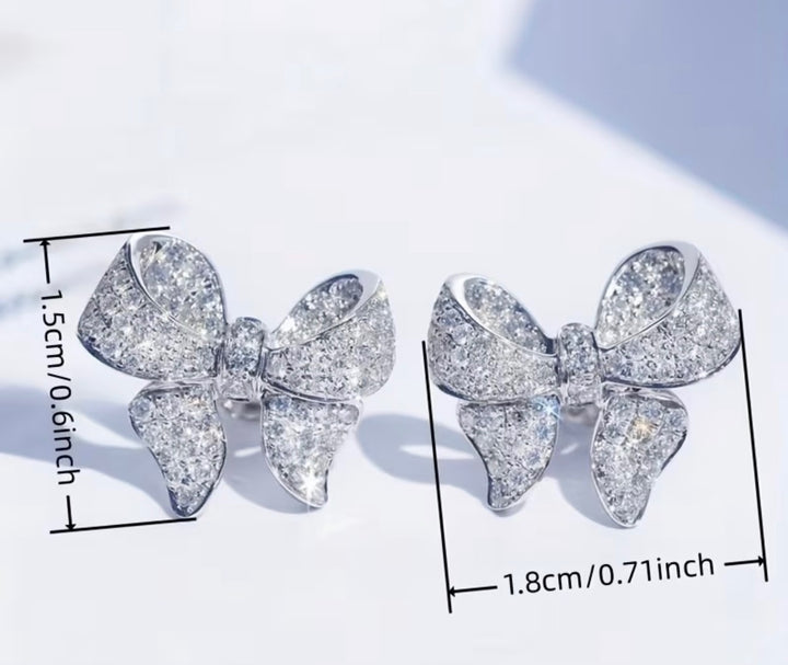 Sparkling crystal bow stud earrings silver tone