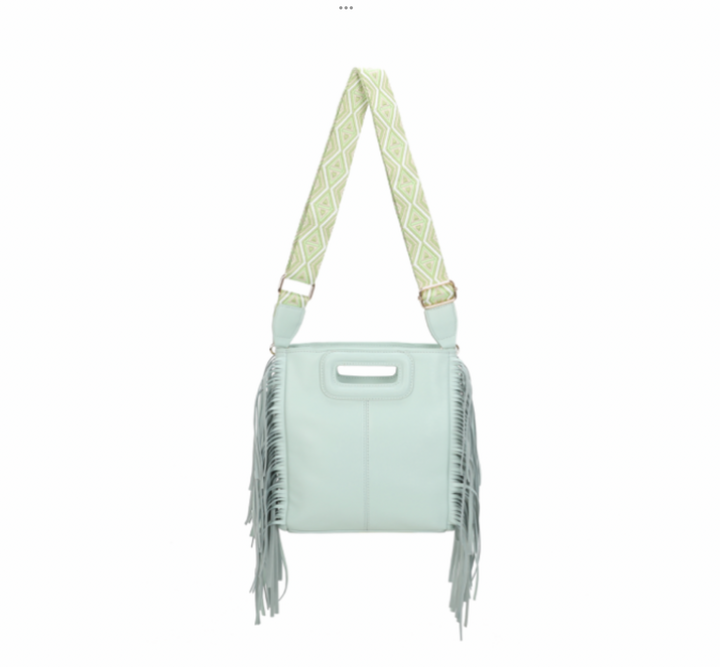 Mint green handbag with fringe details and a patterned strap 