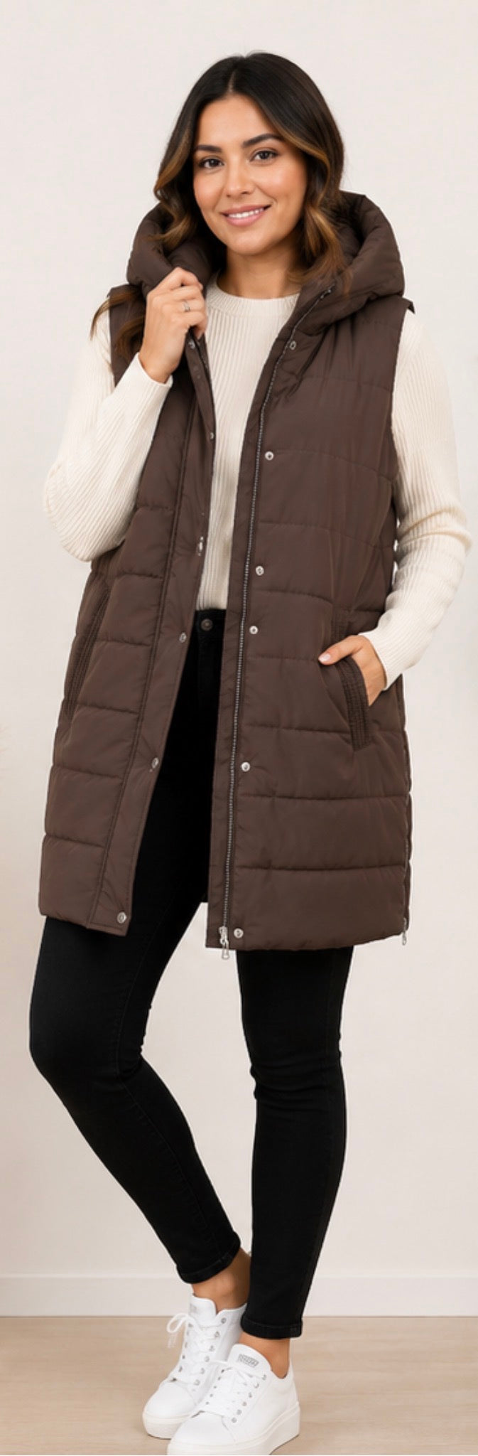 Long brown padded gilet with hood, quilted design and front zip fastening, sleeveless puffer bodywarmer with pockets
