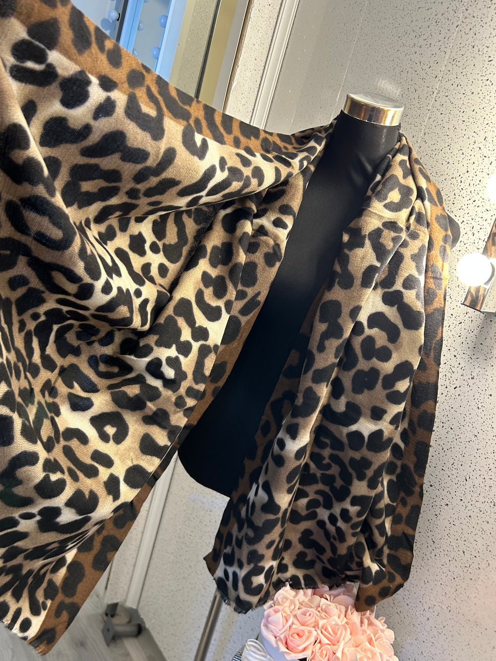 A leopard print scarf with frayed edges