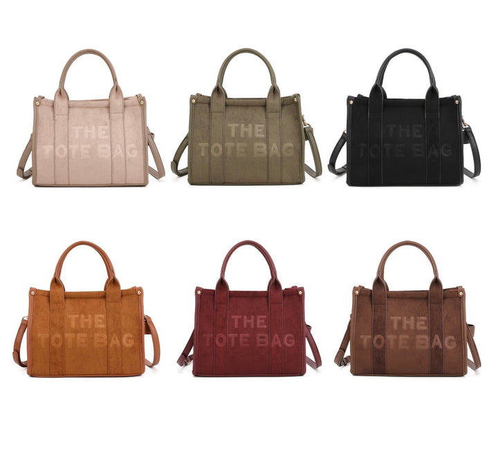Small faux suede tote bag with top handles and shoulder strap available in multiple colours.
