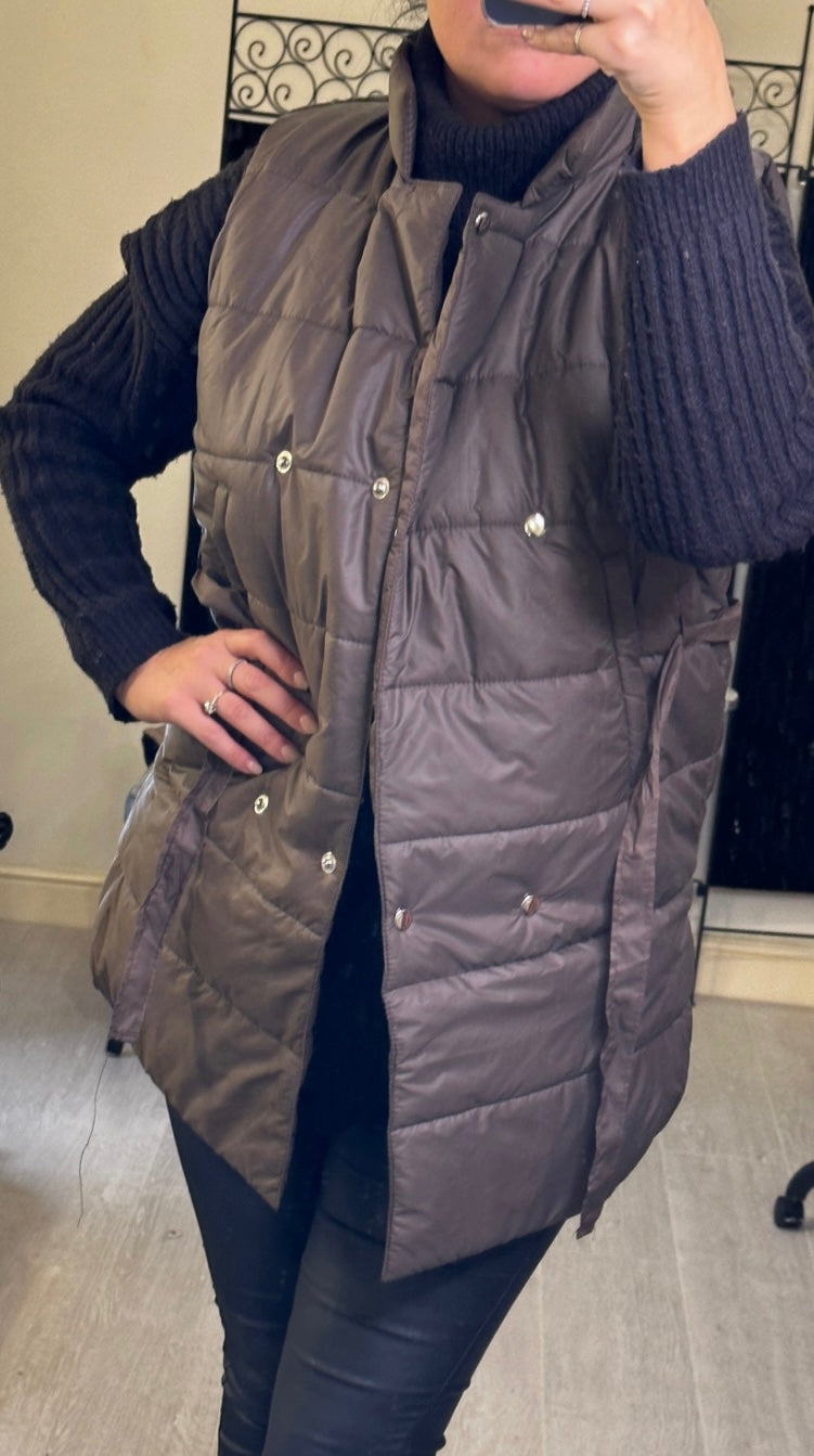  mid-length gilet, one in brown with ribbon belt shown open
