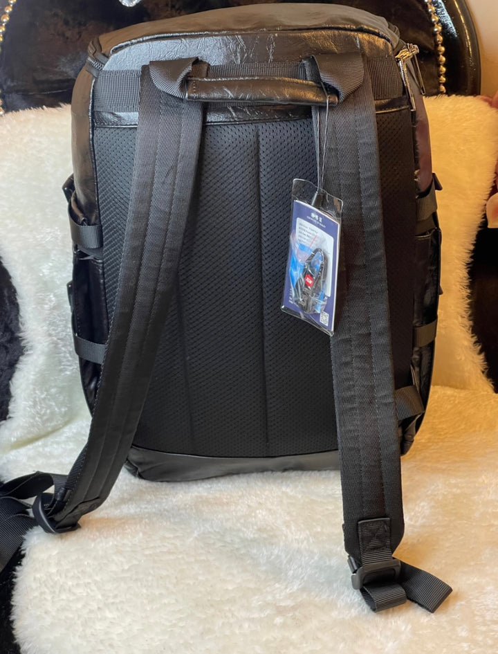 large black leather-look backpack with multiple zip compartments, adjustable straps and modern design, practical travel and work bag