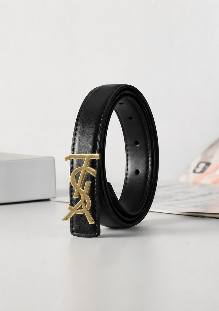 Black slim faux leather belt with gold-tone statement buckle.