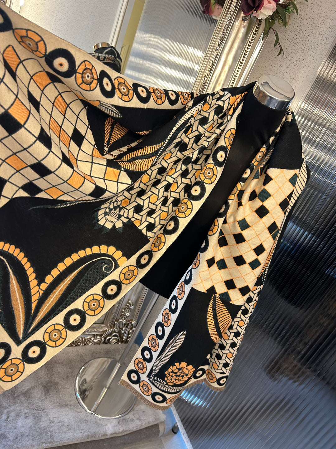 Black geometric scarf with beige and orange accent