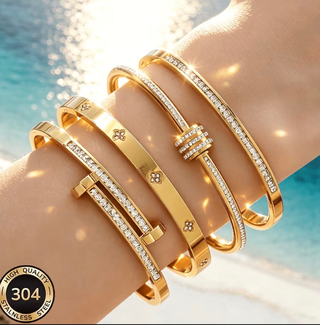 Luxury gold-tone stainless steel bangle bracelet collection with crystal detailing