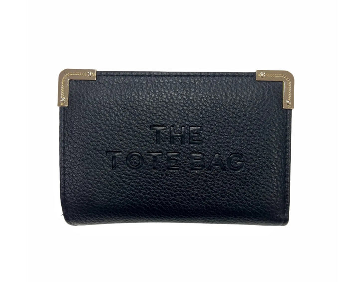 A black synthetic tote bag with gold tone metal hardware, featuring a fold-over top with a closure, and the THE TOTE BAG&
