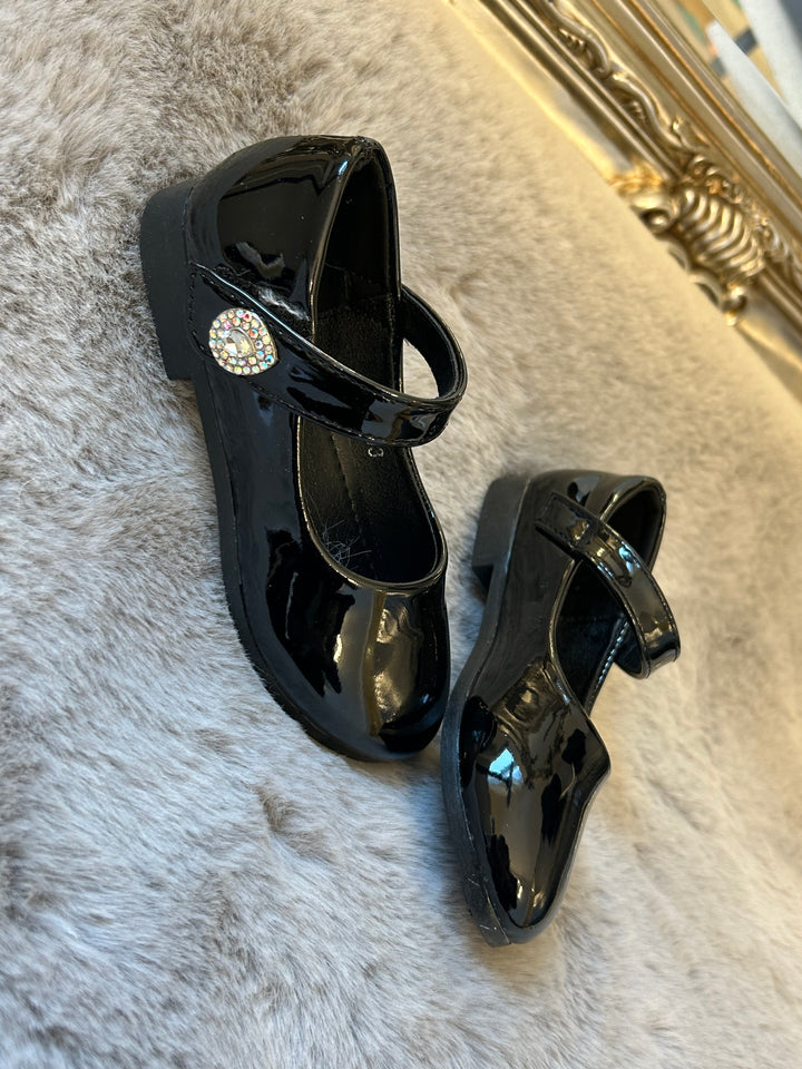 A pair of black, patent leather little girl&