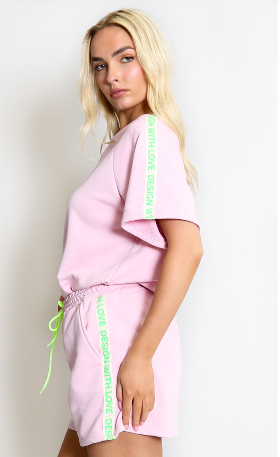a pink outfit with green text 