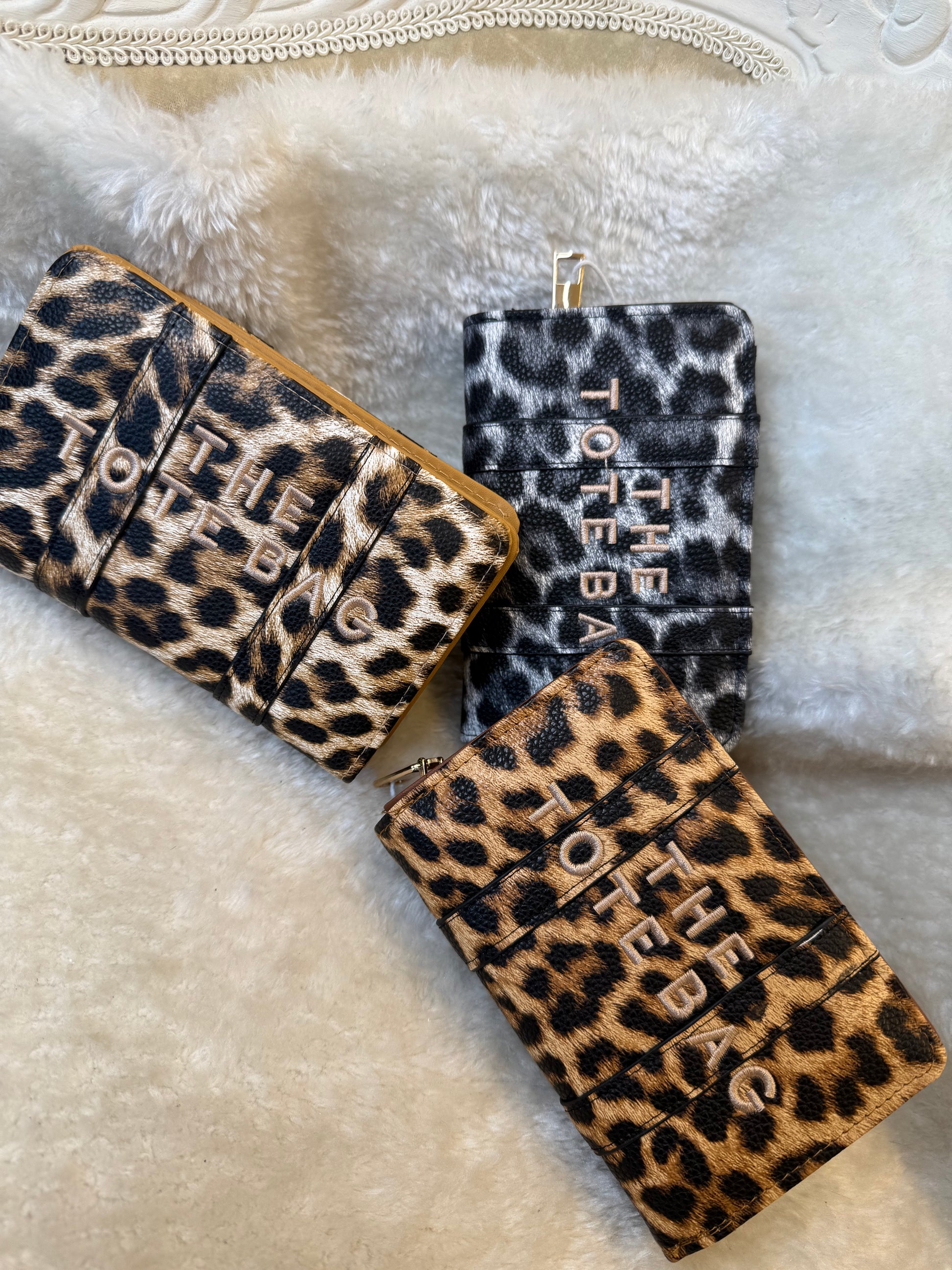 Leopard animal print card holders purses with embossed ‘The Tote Bag’ lettering and gold zip detail
