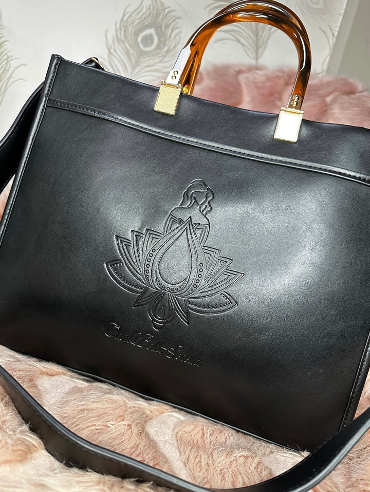 black faux leather tote bag with the cbs logo on the front