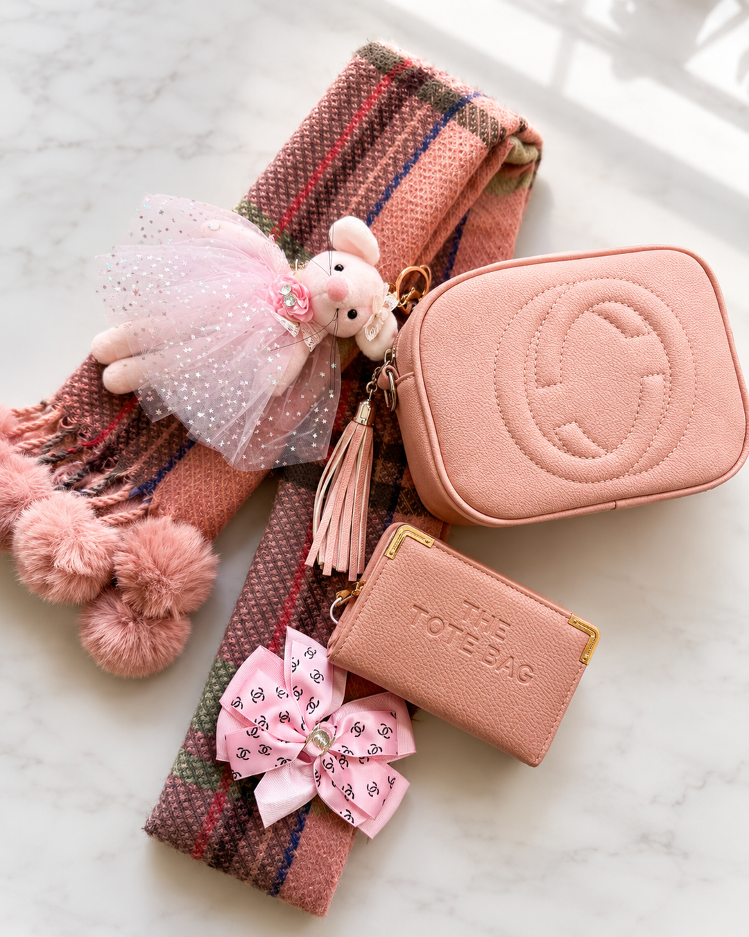 Luxury handbag bundle featuring a matching handbag, coordinating purse and elegant scarf styled together 